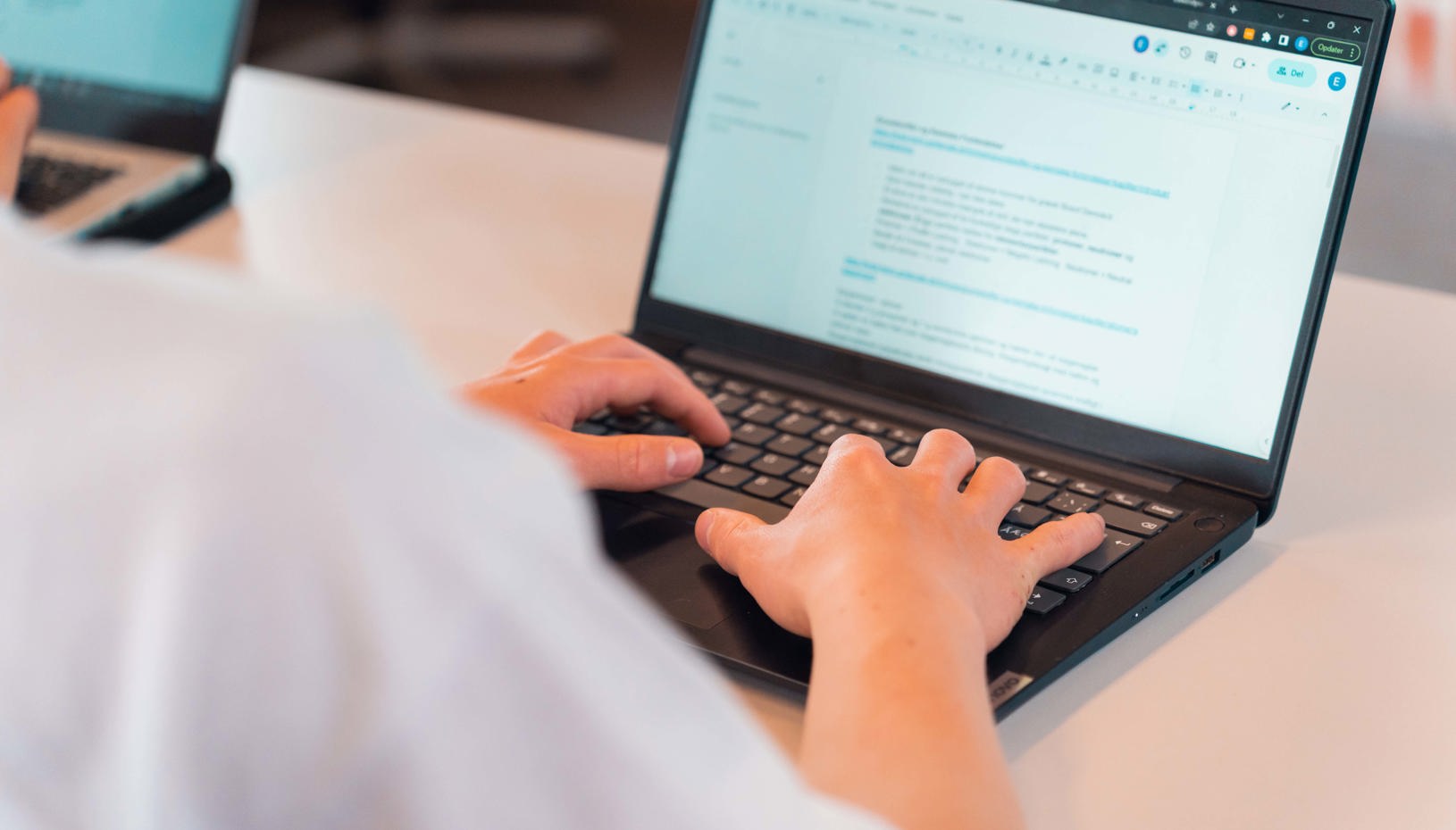 Elev skriver på computeren